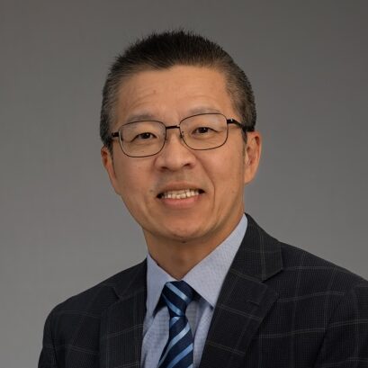 asian man with dark hair and glasses