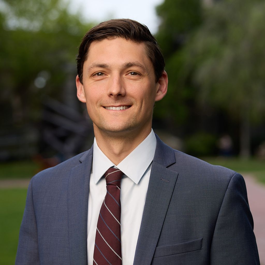 white man with dark hair in a suit