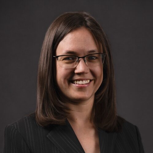 woman with dark hair and glasses