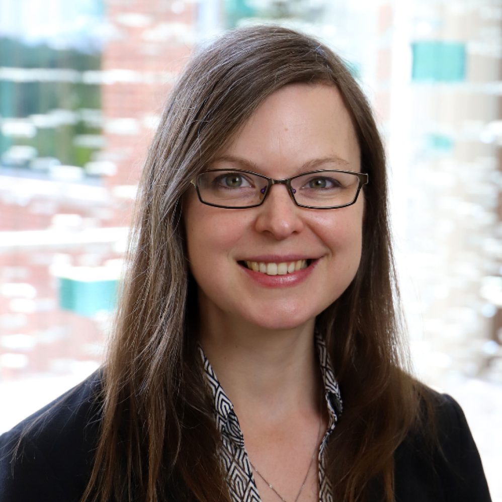 woman with dark hair and glasses