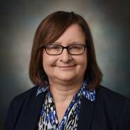 woman with dark hair and glasses