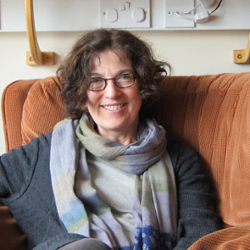 woman with short dark hair and glasses