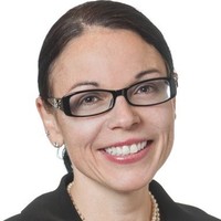 woman with dark hair and glasses